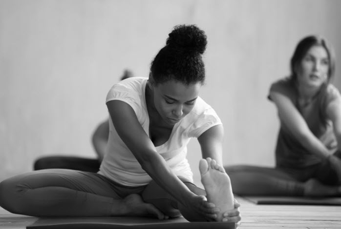young woman participates in yoga class
