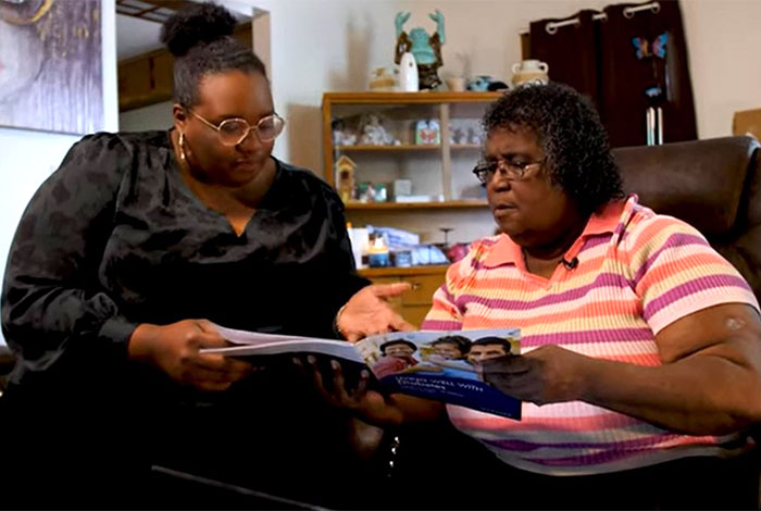 Two women reviewing a brochure